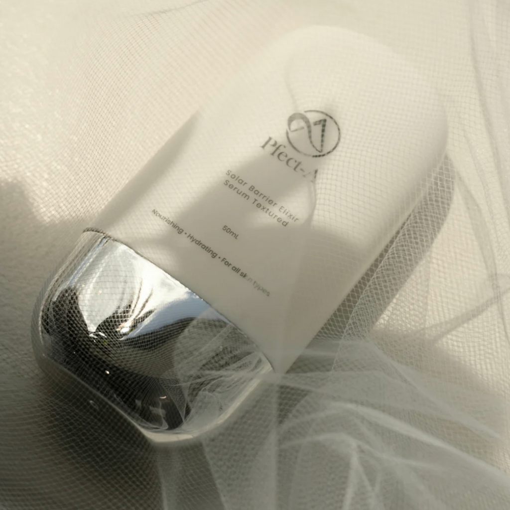 Pfect-A Solar Barrier Elixir daily face serum styled on sheer fabric
